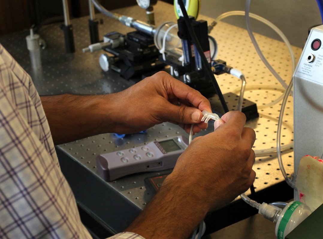 In order to design an effective and sustainable solution, a wide range of factors are considered. Here a shop technician works on the design for a neonatal respiratory device. Photo: PATH/Tom Furtwangler.