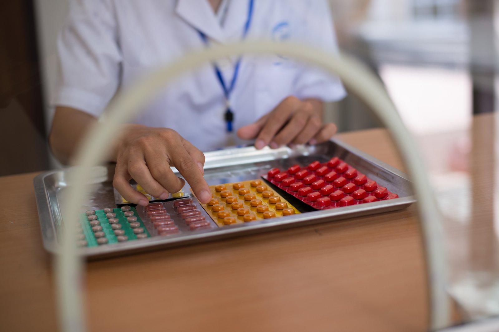 A pharmacist at the Chuong My district health center in Vietnam reviews supply of medicine for TB treatment. Photo: PATH/Matthew Dakin.