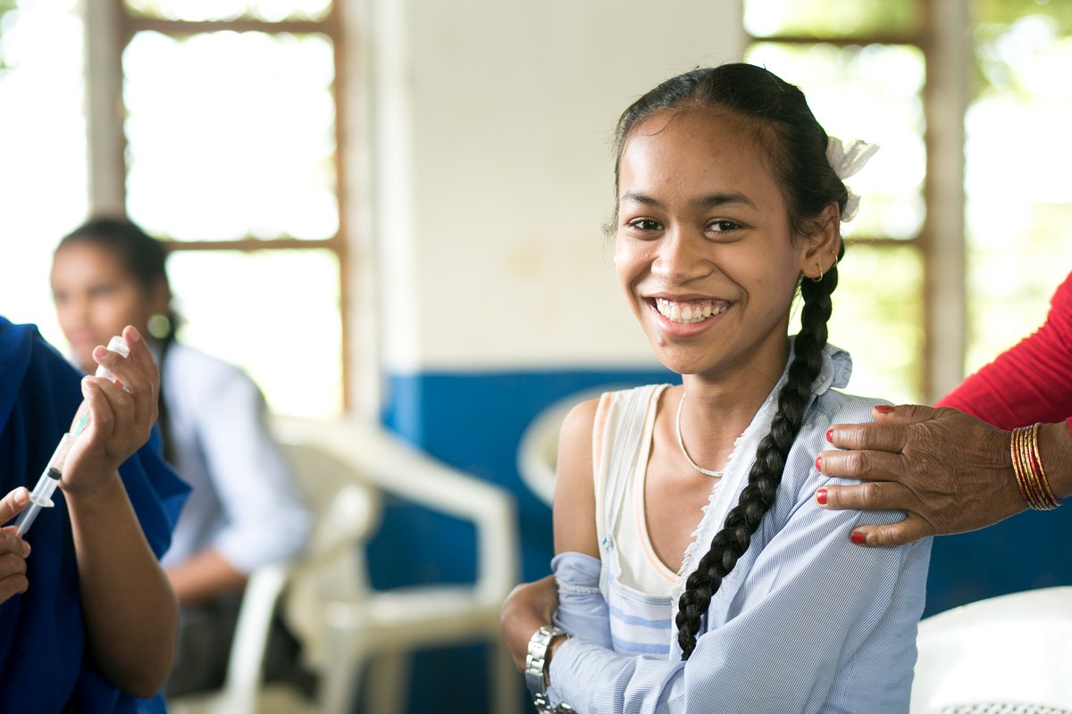 A girl in Nepal holds her shoulder after she has received her Japanese encephalitis vaccination 22999.jpg