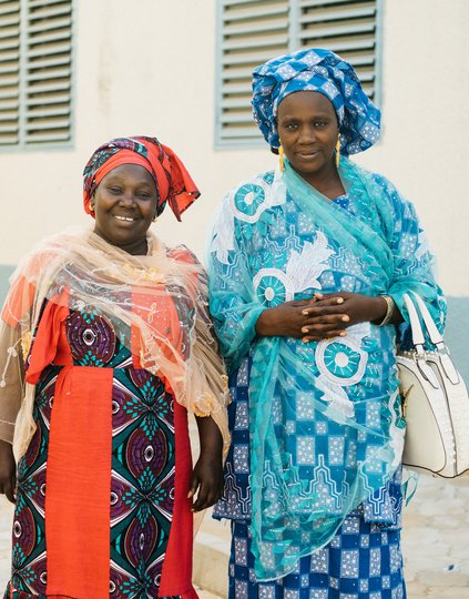 Aida (left) and Mame Fama Male (right in blue) are community health educators in Pikine, Senegal, who educate women about their family planning options. PATH/Gabe Bienczycki