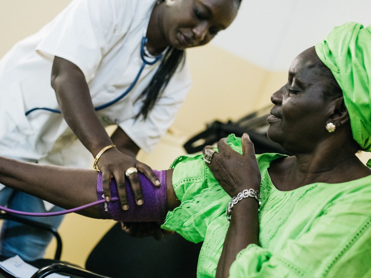 A doctor meets with diabetes patient Fatou Gueye for a routine check-up and blood pressure check.