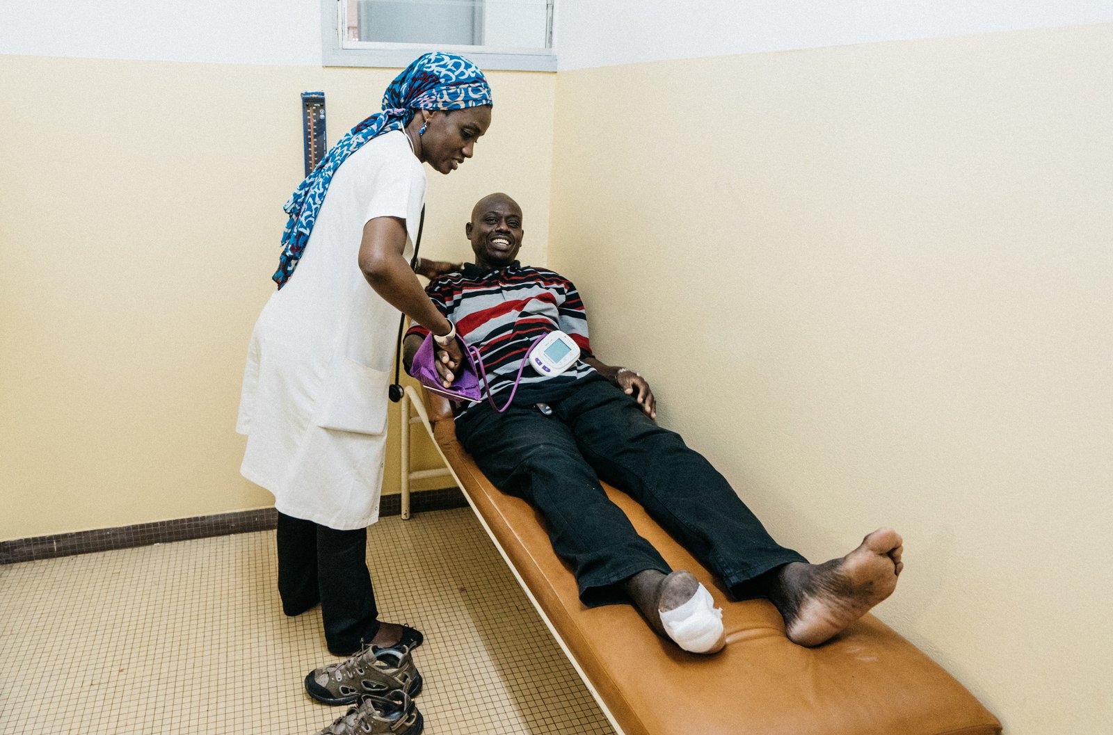 A patient meets with a healthcare worker in a clinic.