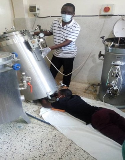 Biomedical engineers Haule Selwin and Aron Mahofu diligently rectify and restore malfunctioning medical equipment at Bunda District Designated Hospital in the Mara Region, Northern Tanzania.   Photo: PATH/Jackson Mugyabuso.