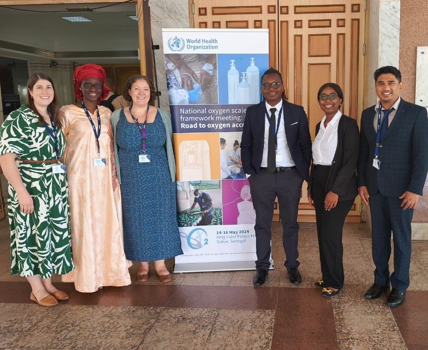 PATH staff at the May 2024 World Health Organization National Oxygen Scale-Up Framework Meeting. Left to right: Lisa Smith, Ndeye Astou Badiane, Carrie Hemminger, Raphael Kayambankadzanja, Inutu Kanyama, and Jayendra Kasar. Photo: PATH.