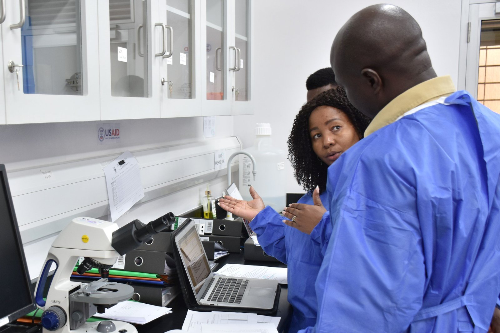 A SANAS assessor asks questions to the Laboratory Manager at Uganda Wildlife Authority Diagnostic and Research Laboratory in Queen Elizabeth National Park Photo: PATH/ Deogratias Agaba.
