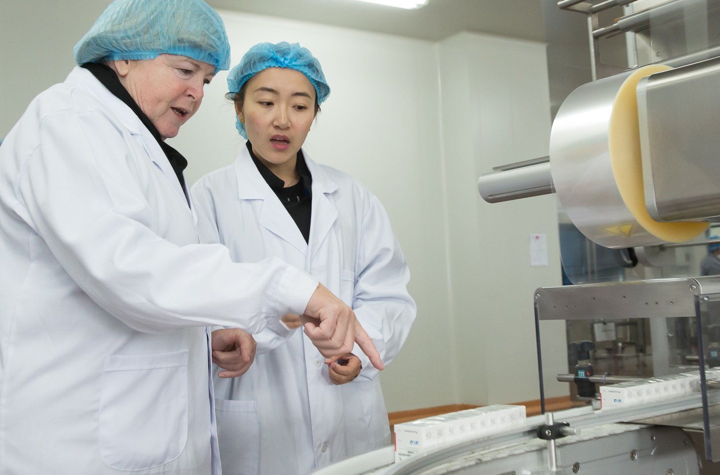 Kathy Cahill talks with a lab attendant during the China Journeys trip.