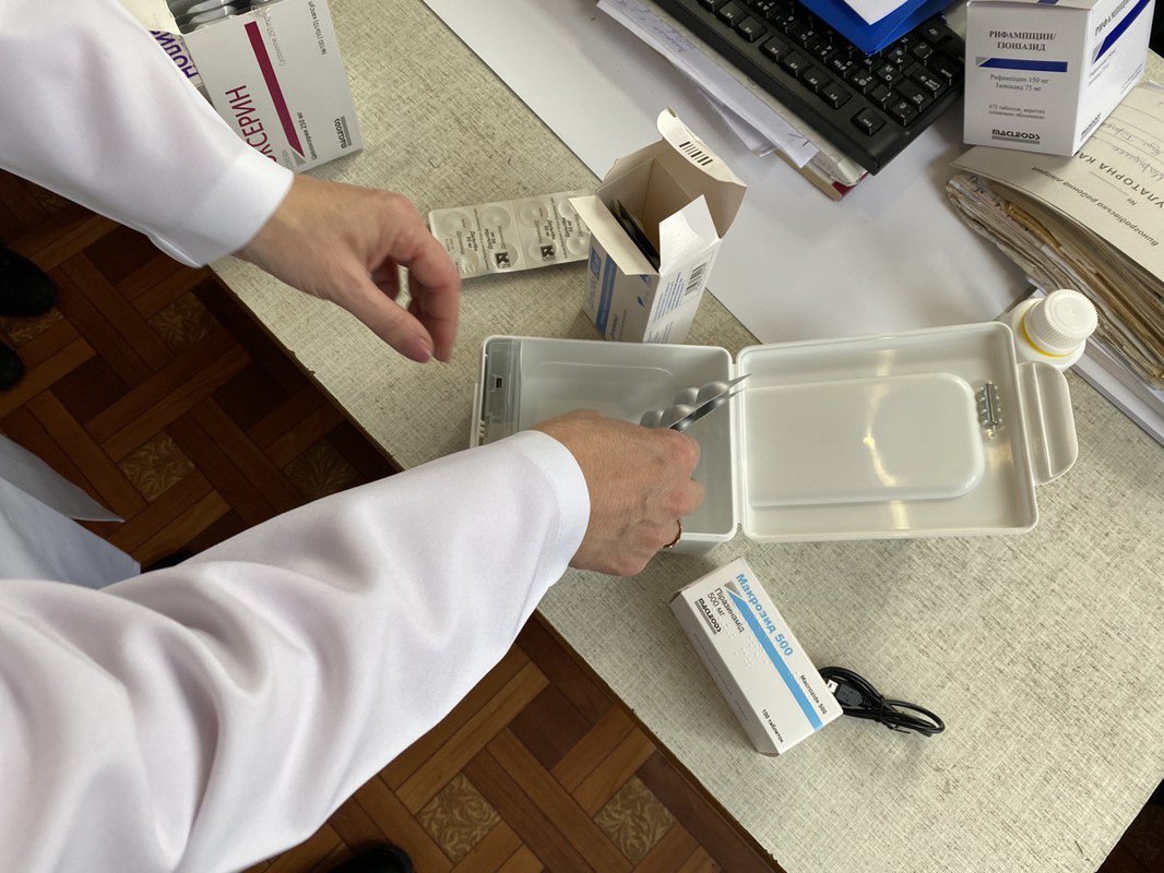 A health care worker at the Vynohradiv TB facility in Zakarpatska Oblast, Ukraine prepares a smart pill box with a patient’s monthly supply of TB medication.