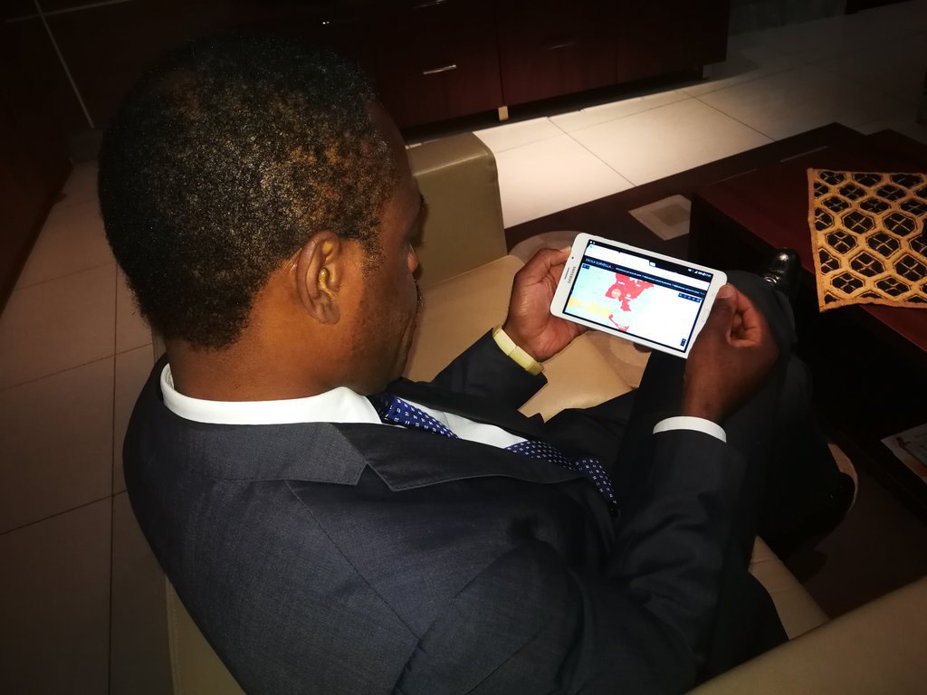 Minister of Health Dr. Oly Ilunga using a tablet to monitor the Ebola response.