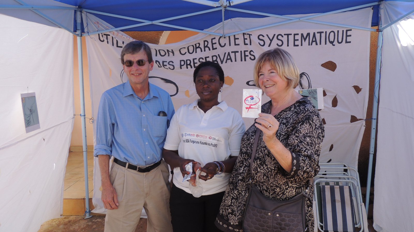 David Fleming, a health care worker, and Kathy Cahill stand in front of a sign.