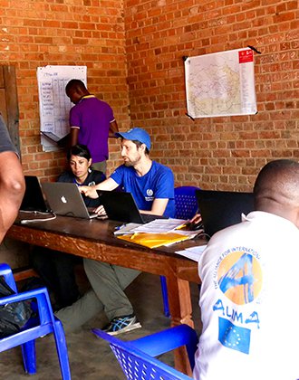 People meet around a large table in a room.