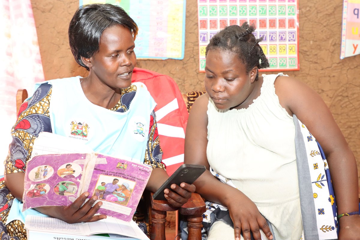 Jackline Vugutsa, a community health promoter, uses a mobile device to collect data during a household visit in Vihiga County.  Photo: PATH/Denise Akun.