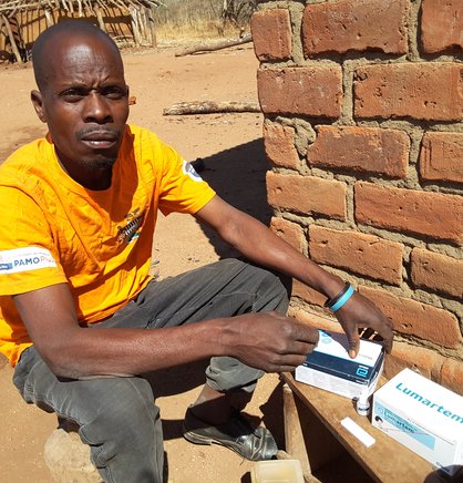Masauso Mbewe at his home in Lusangazi District, preparing for a community case management session. Photo: PATH.