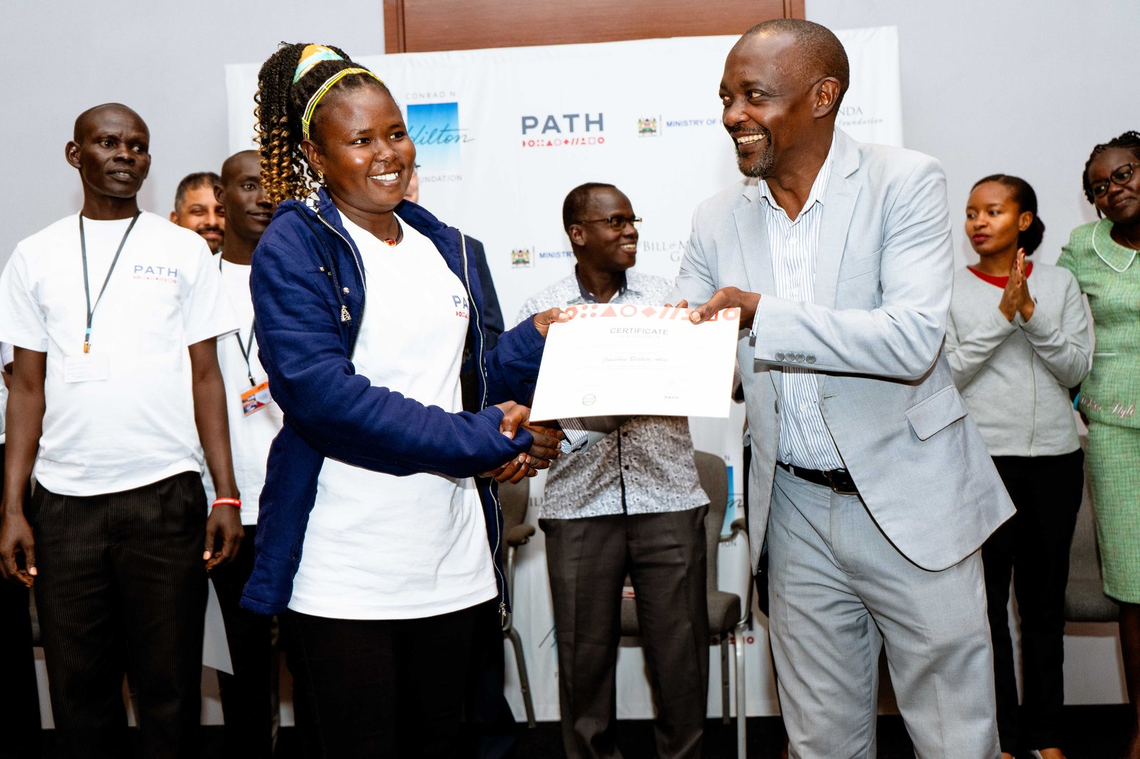 Photo: PATH. Josephine Akai Bakhita, the Subcounty EPI lead for Turkana central, receives a certificate for collaborating with the Living Labs team in applying HCD to understand determinants of demand, co-create and test solutions, in her Turkana County.