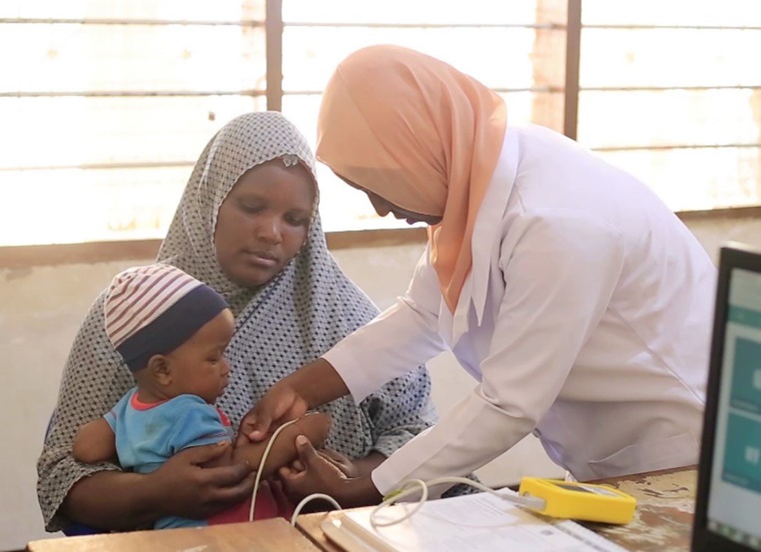 Fatina Msangi, medical doctor at Duga Health Center in Tanga, attending to a sick child. Photo: PATH/Olgah Odek.