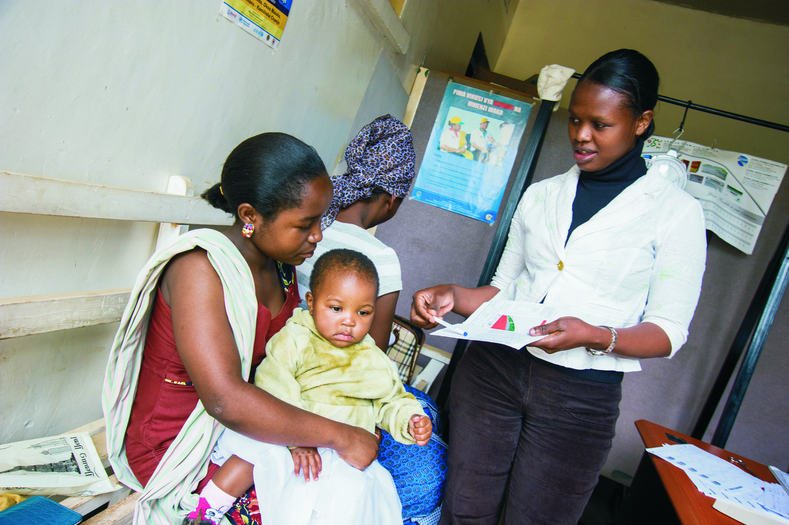 Health provider Caroline Agade advises a mother on her child's immunization schedule at the Green Hope Dispensary in Arusha, Tanzania. Digital solutions will help her deliver better quality care to patients. Photo: BMGF/Riccardo Gangale.