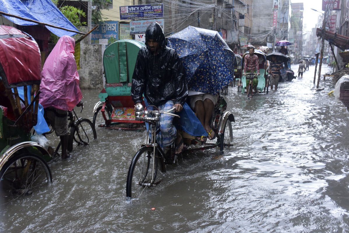 Rickshaw pullers on a flooded street in Dhaka, Bangladesh. Climate change is changing the way we look at everything—including health systems.  Photo: Sk Hasan Ali.