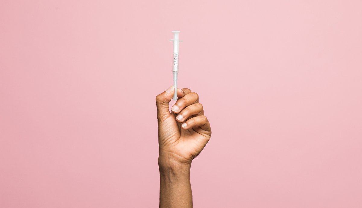 PATH image of syringe in hand on pink background syringe-hand-on-pink-2000-MB25944.jpg