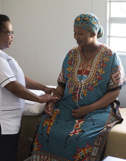 An expectant mother receives prenatal care at a clinic in South Africa. The vast majority of health services worldwide are delivered at the primary health care level. Photo: PATH/Charles Meadows.