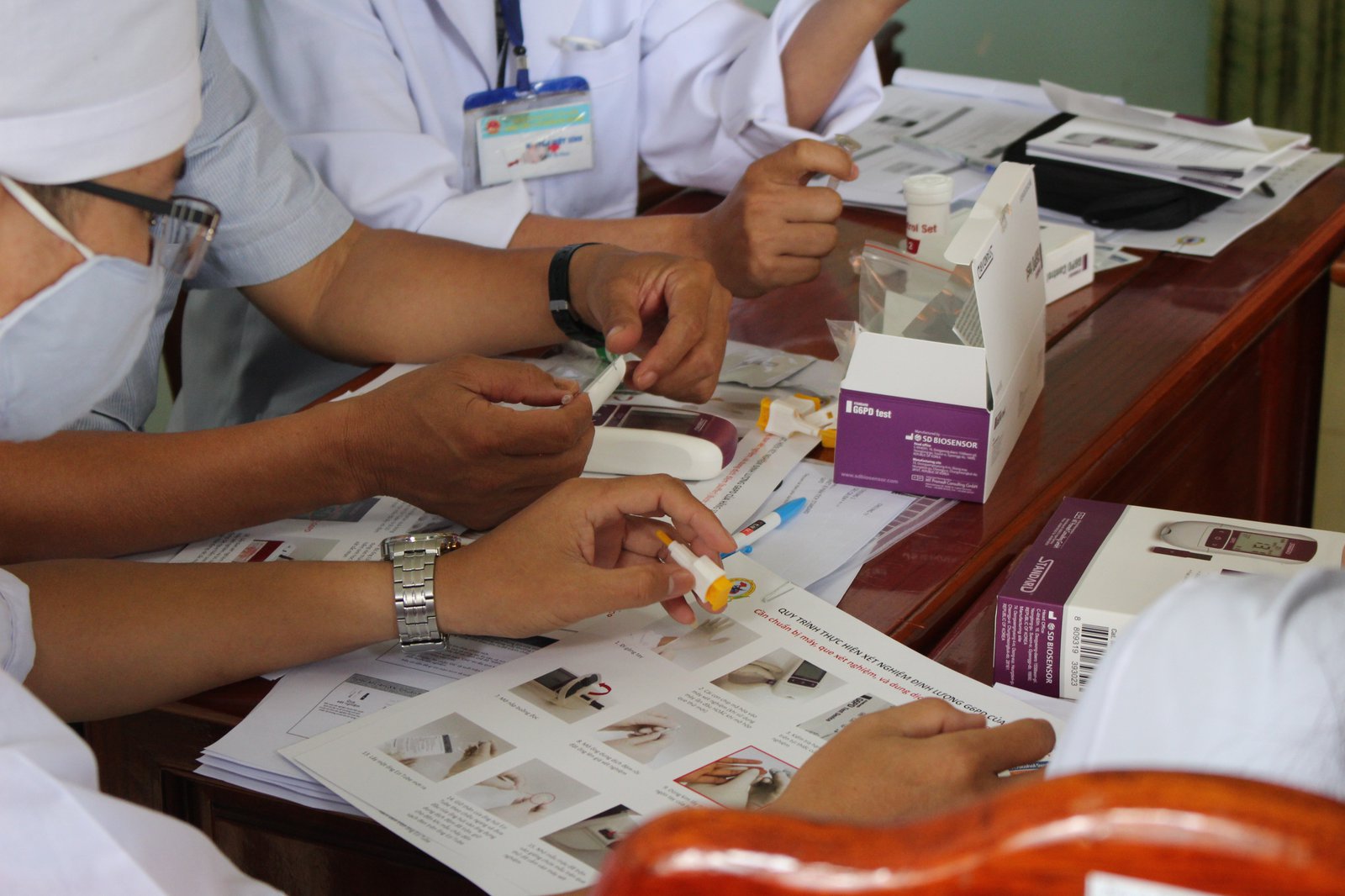Vietnam_10.20_G6PD_8.JPG PATH staff train community health workers in Bình Phước Province, Vietnam, on how to interpret G6PD diagnostic tests and record results. Photo: PATH/Spike Nowak.