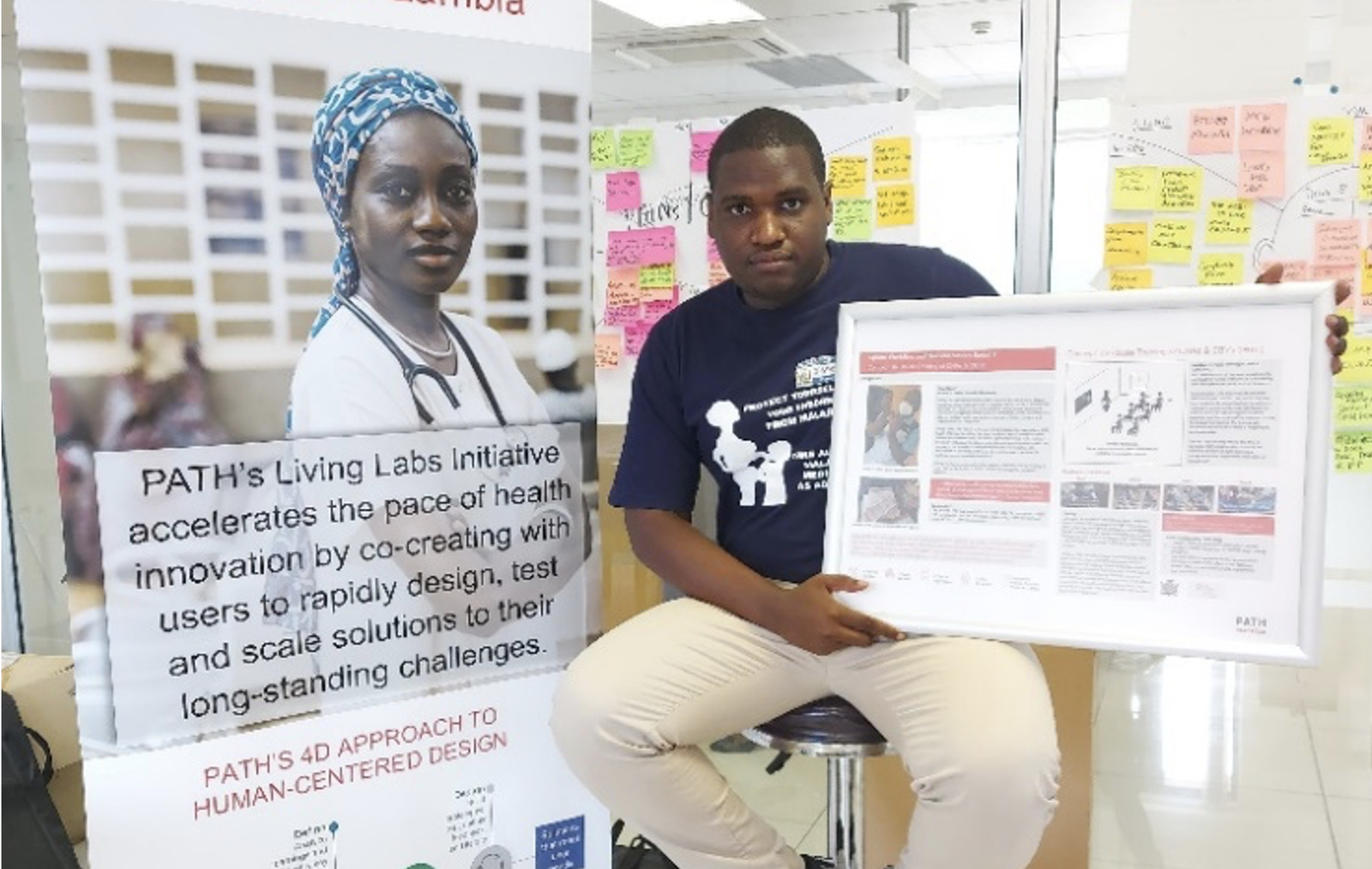 Brian Mushaukwa displays the Living Labs Initiative materials to educate stakeholders on the projects in Zambia. Photo: PATH.